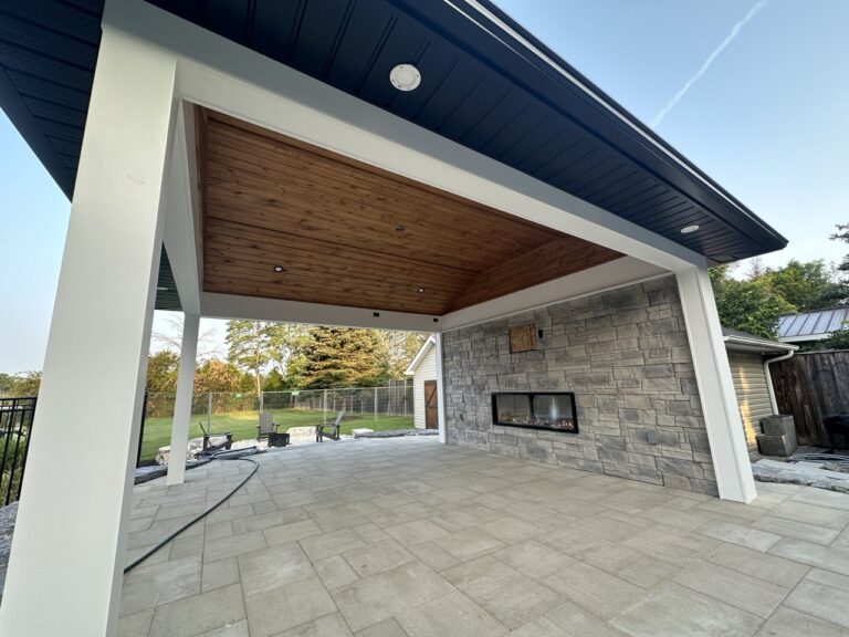 A modern pool house under construction featuring wood framing and large glass panels